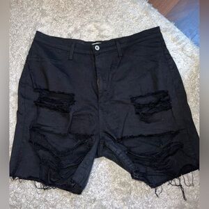 Black destroyed Bermuda shorts